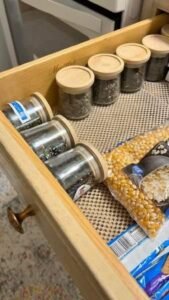 organized rv kitchen drawer with glass jars